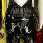 Close-up of the Evelyn Chevalier rear waistband showing gathered black fabric, crossed straps and gold tassels
