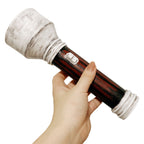 Hand-held angled view of the Feng Min flashlight prop showing the weathered white head, dark striped handle and switch detail