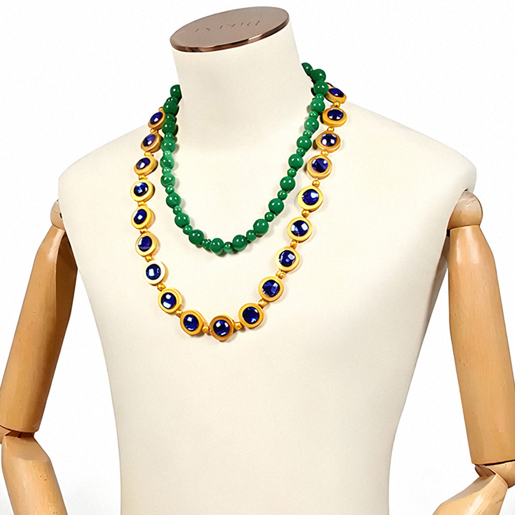 Blackbeard Marshall D. Teach green beaded necklace and longer blue-and-gold-colored necklace displayed on a mannequin