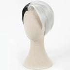 Three-quarter view of the Divus Crewel wig showing the curved white side section and contrasting black hair