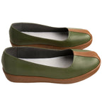 Side view of the Iroh olive green slip-on shoes showing the low profile and brown sole edges