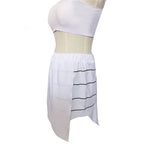 Close-up of the Katara white skirt showing the gathered waistband and black-striped side panel