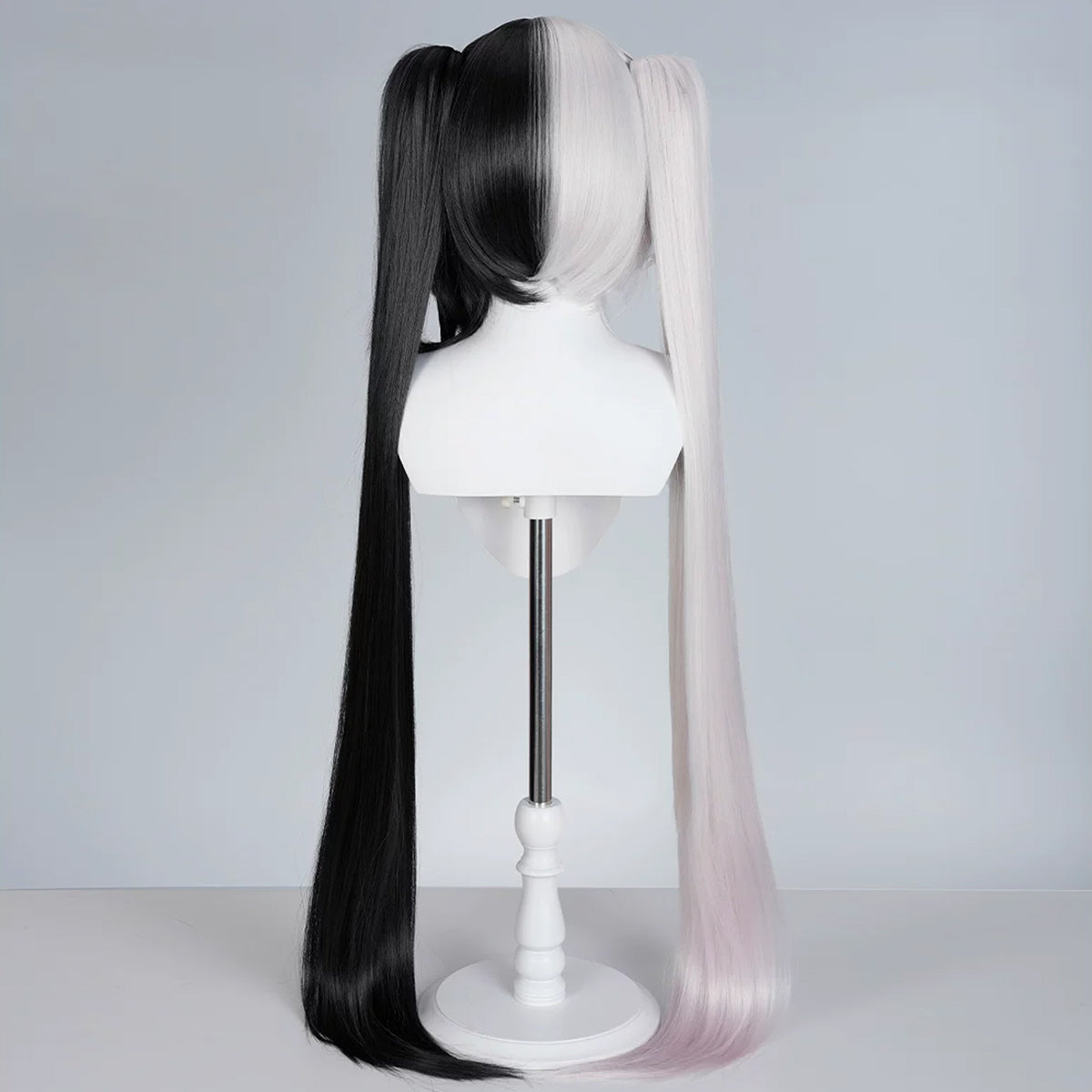 Back view of the Sparxie black-and-white wig showing the split-color short base and long twin tails