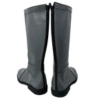 Rear view of the Aang tall gray boots showing full-length black zippers and low black heels