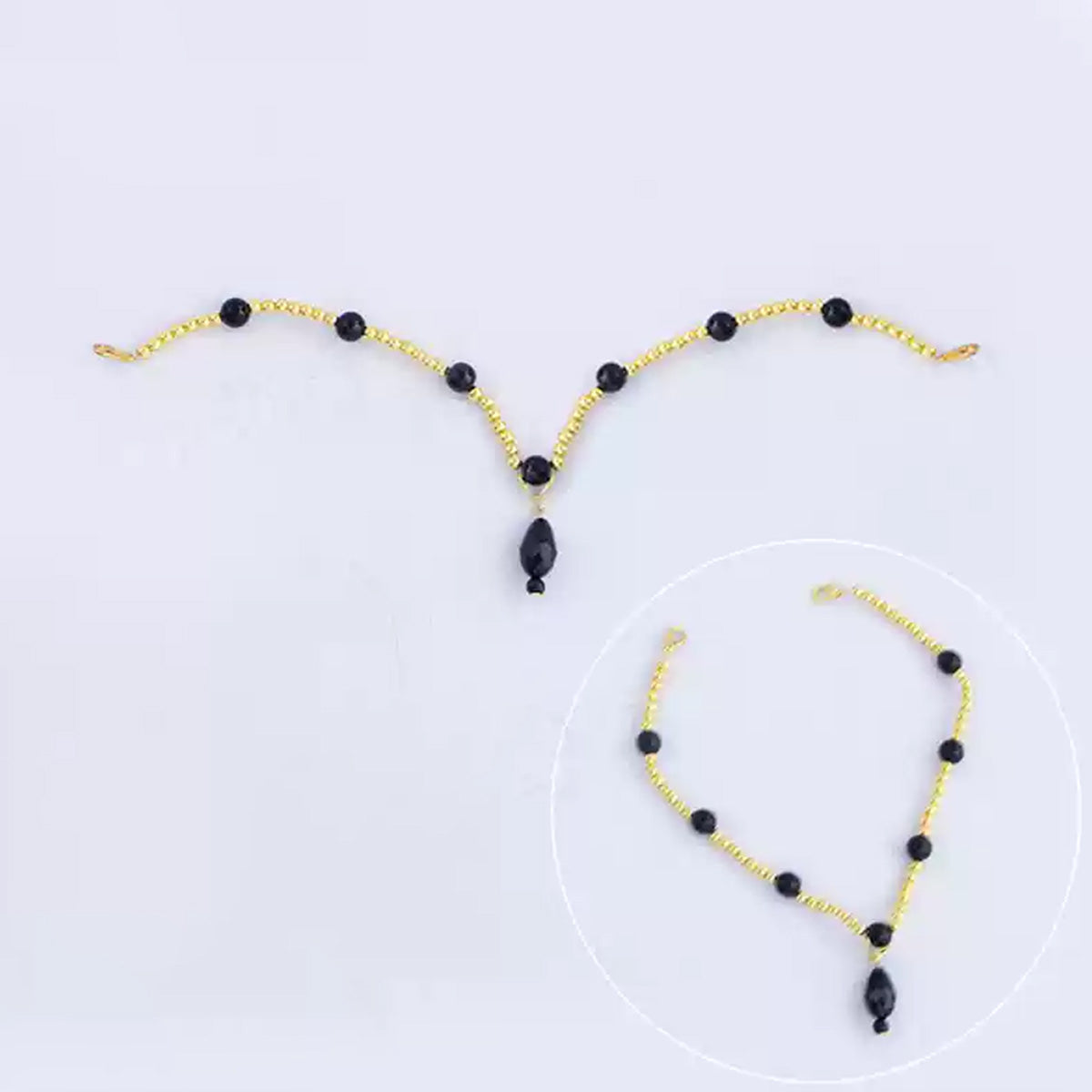 Fiona Gilman Crimson Priestess forehead chain with gold-tone links, black beads and a teardrop pendant
