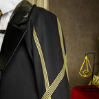 Evelyn Chevalier coat shoulder detail showing intersecting gold stripes beside the glossy black lapel