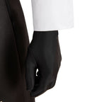 Close-up of the Falco black glove beneath the white shirt sleeve